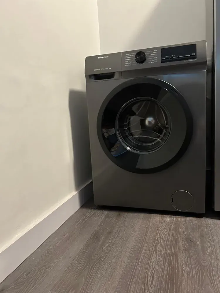 Front-loading washing machine inside a Behomu apartment