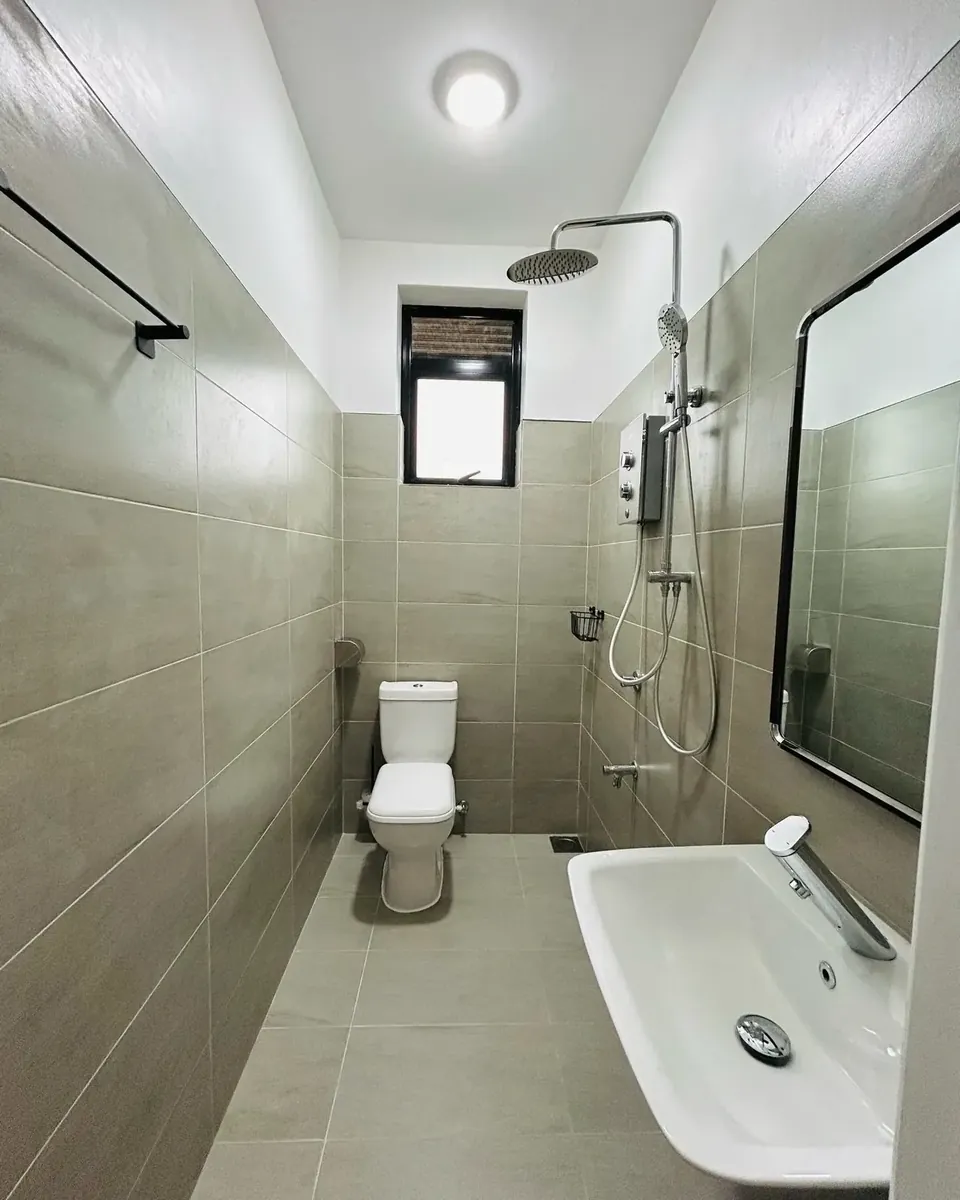 Tiled bathroom with rainfall shower, toilet and washbasin