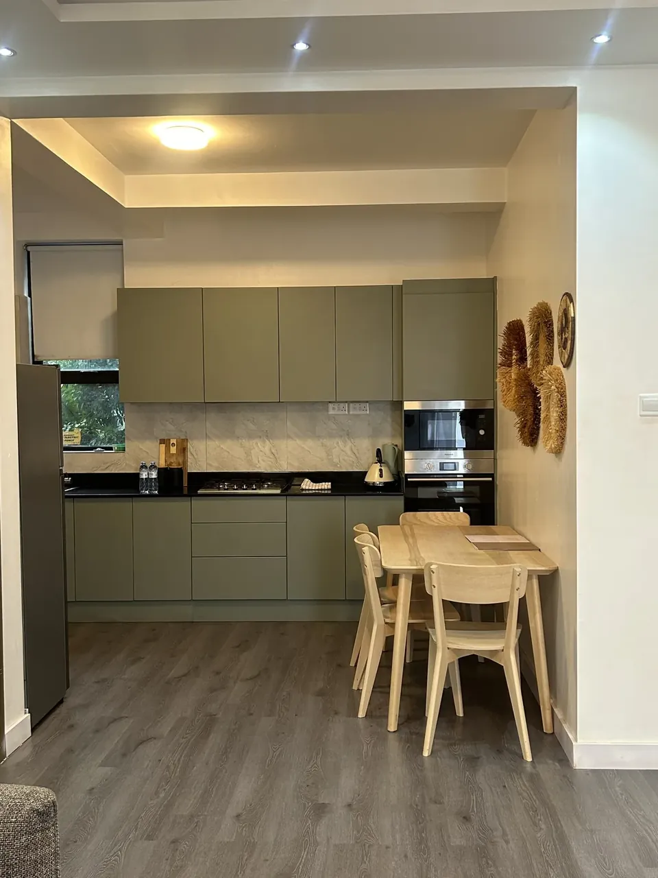 Sage-green kitchen with dining table for four